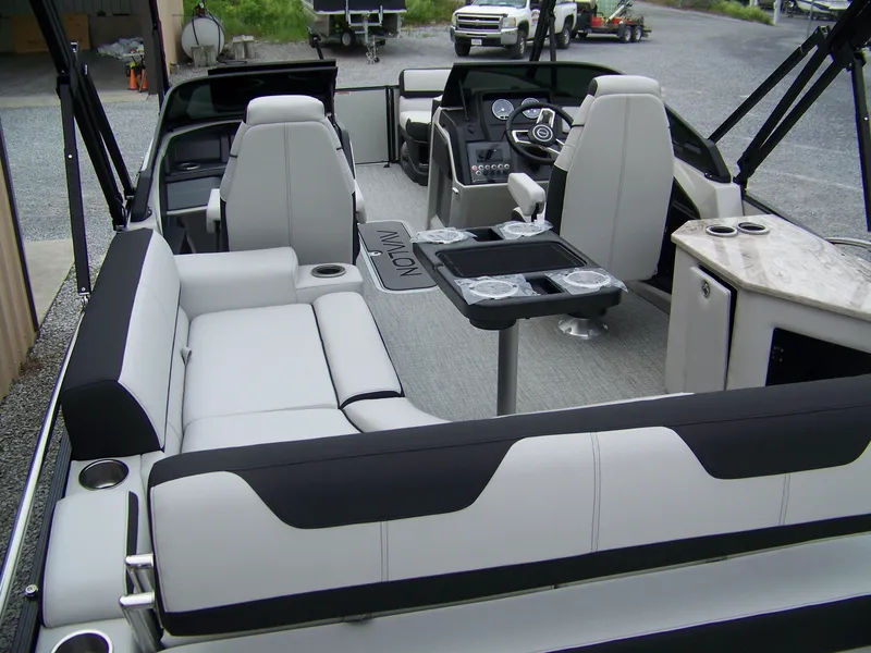 Slide: The Image of 2025 Avalon Catalina Cruise boat interior with rear bench and windshield, featuring modern seating and controls. - 16