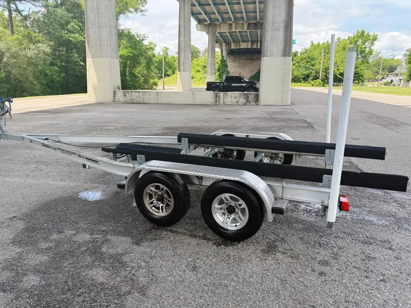 Slide: The Image of Trailer for 2015 Chaparral 244 Sunesta boat parked under a bridge. - 11