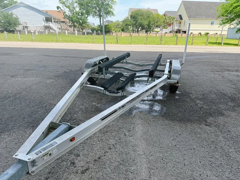 Slide: The Image of Trailer for 2015 Chaparral 244 Sunesta boat parked on asphalt. - 12