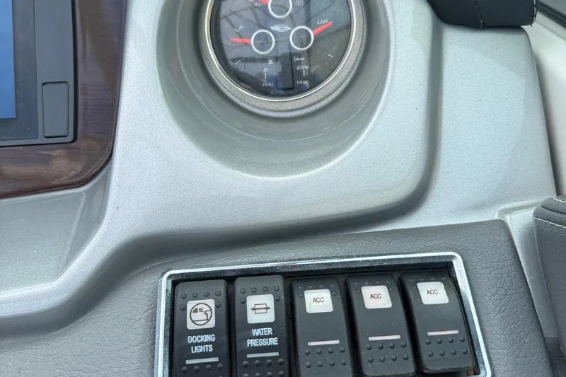 Slide: The Image of Control panel of a 2015 Chaparral 244 Sunesta boat with switches and gauges. - 17