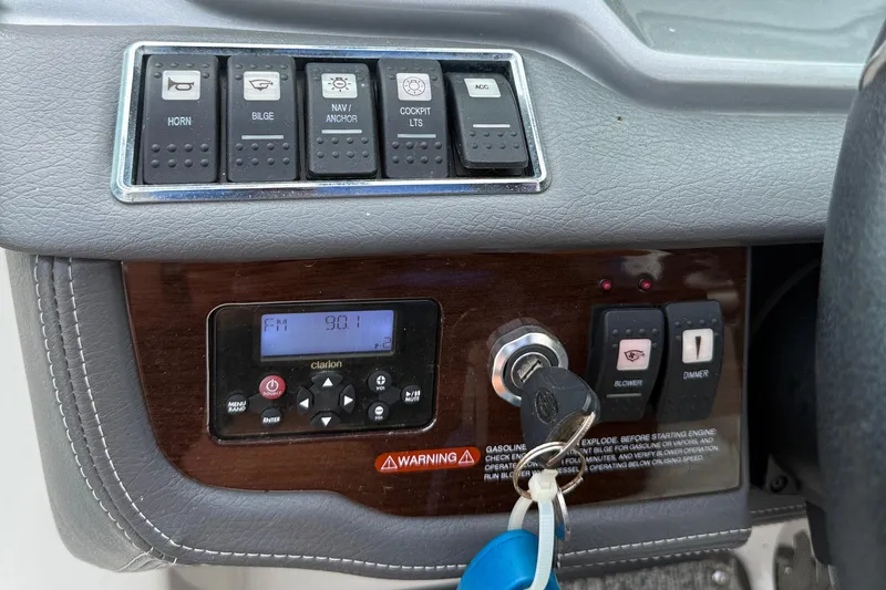 Slide: The Image of Control panel of a 2015 Chaparral 244 Sunesta boat with radio and ignition keys. - 18