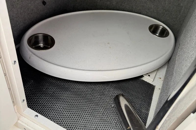 Slide: The Image of Storage compartment in a 2015 Chaparral 244 Sunesta boat with a removable oval table. - 23