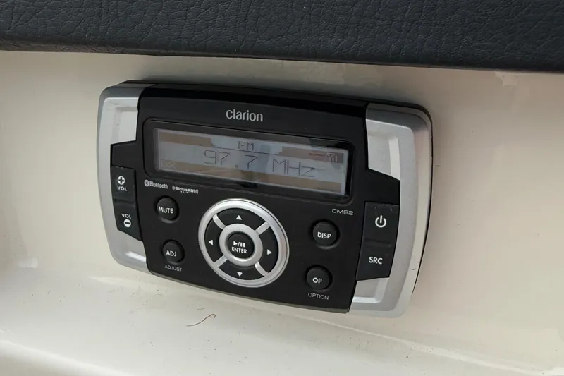 Slide: The Image of Clarion stereo system on 2015 Chaparral 244 Sunesta boat dashboard. - 24