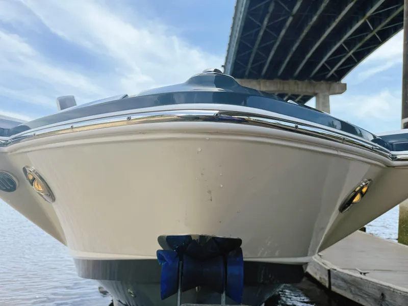 Slide: The Image of 2015 Chaparral 244 Sunesta boat docked under a bridge on a sunny day. - 4