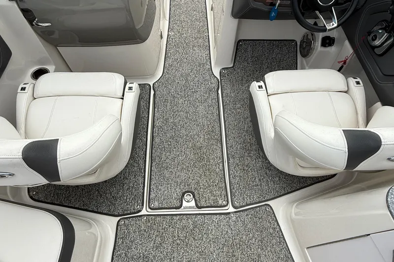 Slide: The Image of 2015 Chaparral 244 Sunesta boat interior with white seats and gray carpet. - 5