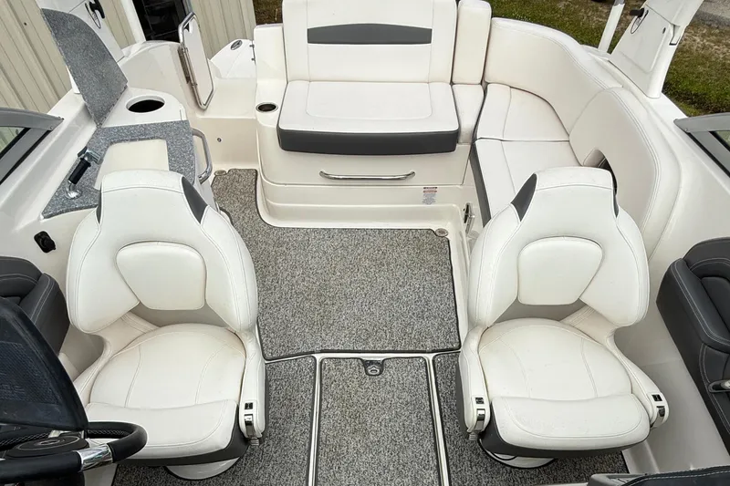 Slide: The Image of 2015 Chaparral 244 Sunesta boat interior with white seating and gray flooring. - 6