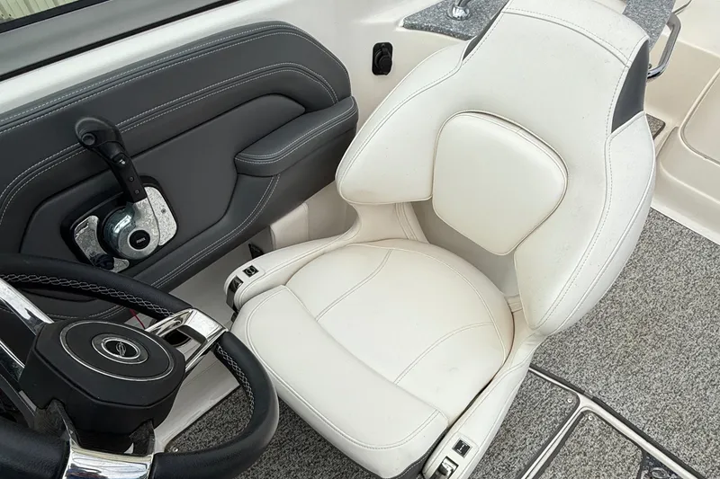 Slide: The Image of Captain's seat and steering wheel of 2015 Chaparral 244 Sunesta boat interior. - 7