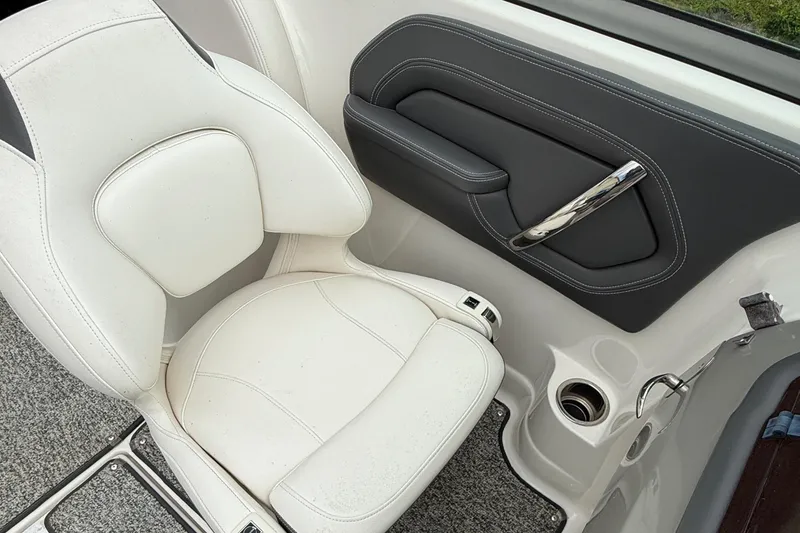 Slide: The Image of 2015 Chaparral 244 Sunesta boat interior with white seat and black armrest. - 8
