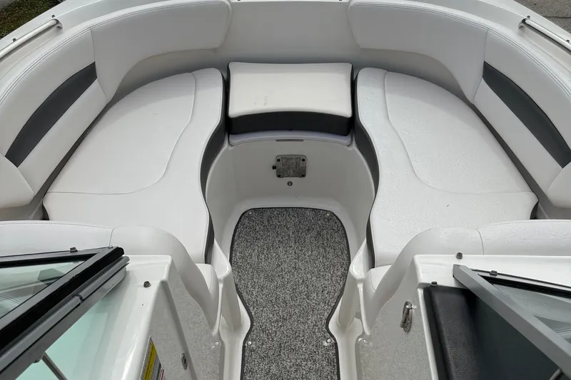 Slide: The Image of 2015 Chaparral 244 Sunesta boat interior with white seating and gray carpet. - 9