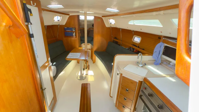 Slide: The Image of Interior of 1998 Catalina 28 MkII sailboat with wood finish and compact kitchen area. - 10