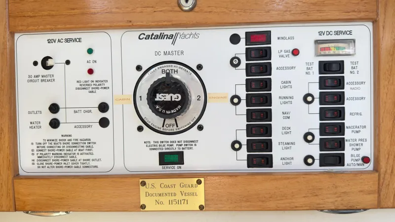 Slide: The Image of Electrical control panel of a 1998 Catalina 28 MkII yacht with various switches and labels. - 16