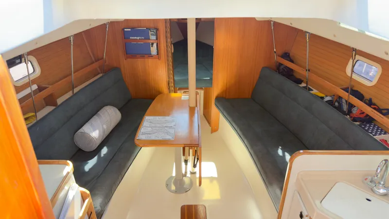 Slide: The Image of Interior of a 1998 Catalina 28 MkII sailboat with cozy seating and wooden finishes. - 17