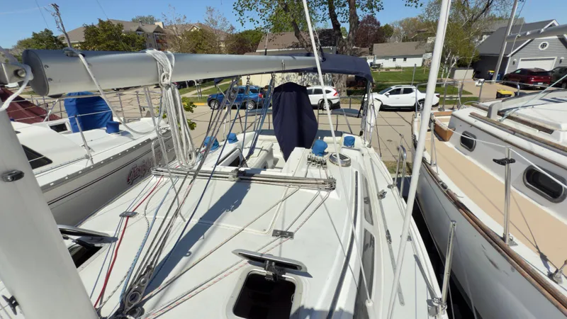 Slide: The Image of Sailboat deck of 1998 Catalina 28 MkII, docked with visible rigging and nearby boats. - 5