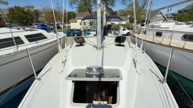 Slide: The Image of 1998 Catalina 28 MkII sailboat deck view with open hatch and surrounding boats. - 6