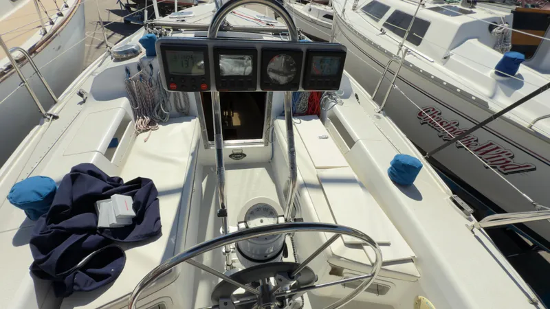 Slide: The Image of 1998 Catalina 28 MkII sailboat cockpit with steering wheel and navigation instruments. - 8