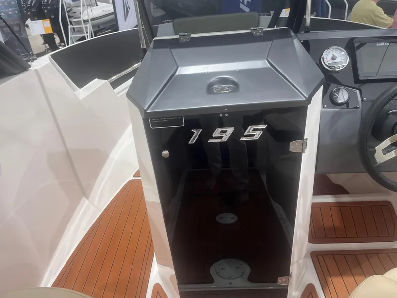Slide: The Image of 2025 Ventura Crossover boat interior with wood flooring and model number 195 displayed. - 7