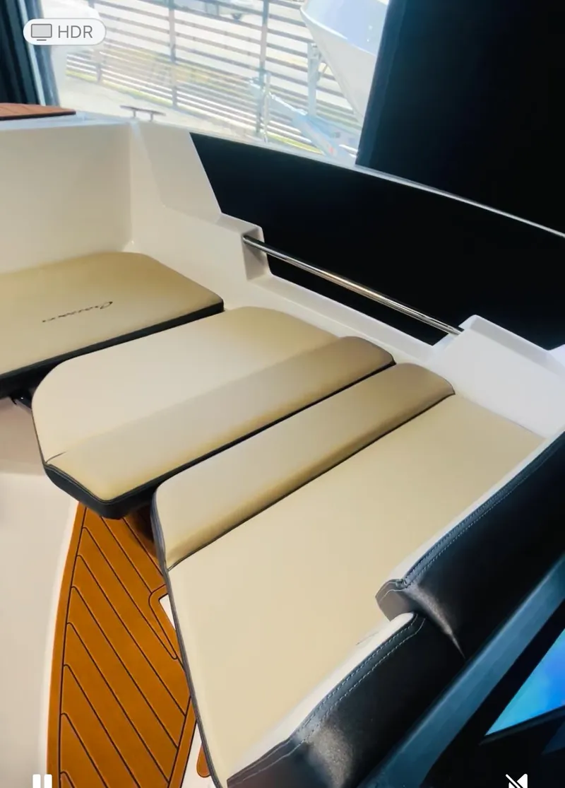 Slide: The Image of 2025 Ventura Crossover boat interior with beige seating and sleek design. - 8