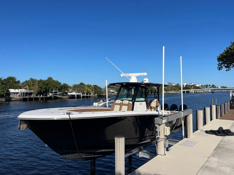 Slide: The Image of 2022 Caymas 341 CC boat docked by a scenic waterfront. - 0