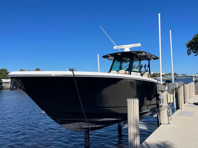 Slide: The Image of 2022 Caymas 341 CC boat docked by the water on a sunny day. - 1