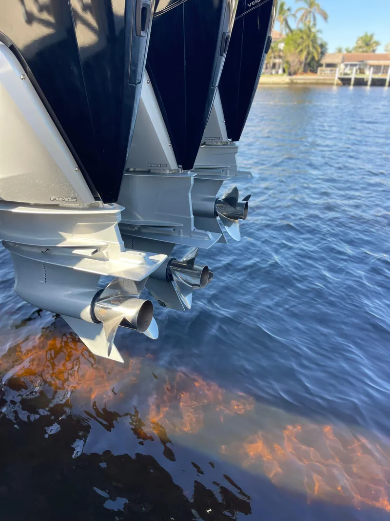 Slide: The Image of 2022 Caymas 341 CC boat engines in water, showcasing powerful outboard motors. - 10