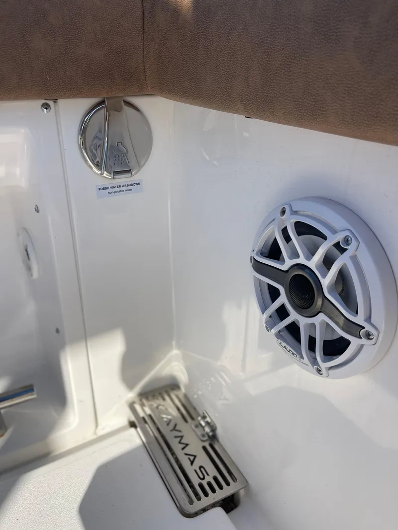 Slide: The Image of 2022 Caymas 341 CC boat interior with speaker and branded drain cover. - 16