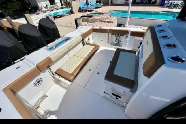 Slide: The Image of 2022 Caymas 341 CC boat interior with seating and storage, near a pool. - 19