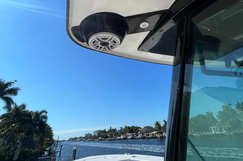 Slide: The Image of 2022 Caymas 341 CC boat with speaker, cruising on a sunny waterway. - 24