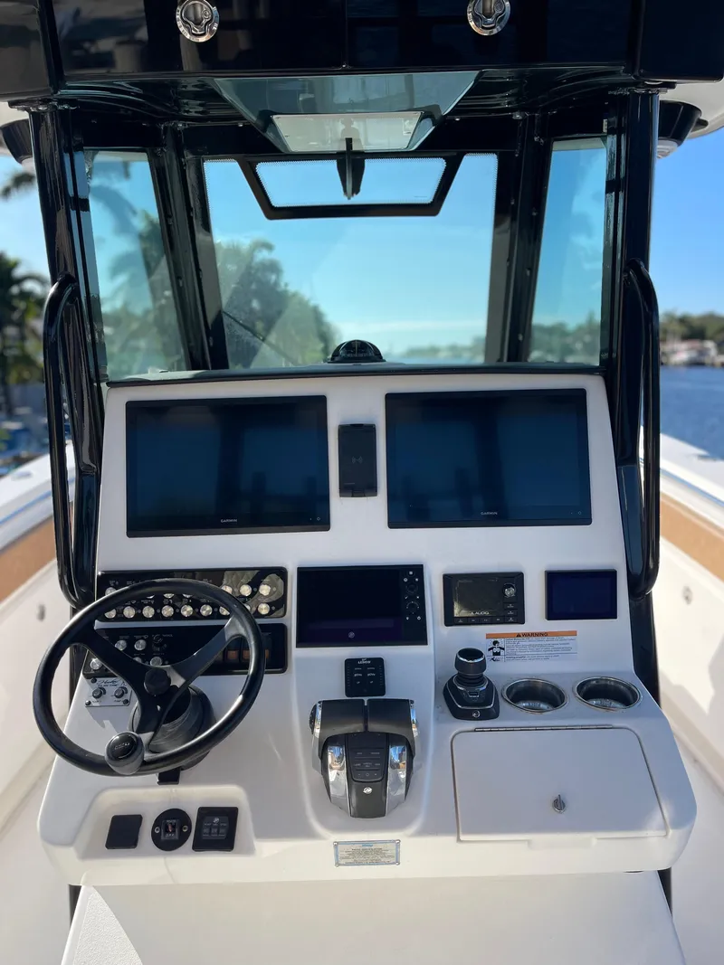 Slide: The Image of 2022 Caymas 341 CC boat dashboard with modern controls and navigation screens. - 29