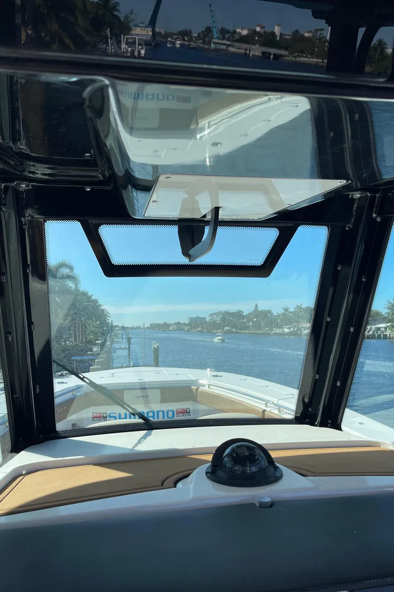 Slide: The Image of 2022 Caymas 341 CC boat interior with waterway view through windshield. - 30