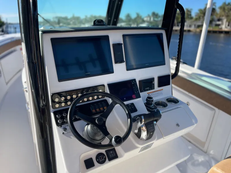 Slide: The Image of 2022 Caymas 341 CC boat dashboard with steering wheel and electronic displays. - 31