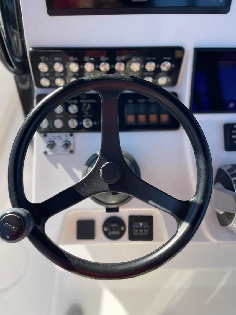 Slide: The Image of Steering wheel and controls of 2022 Caymas 341 CC boat. - 33