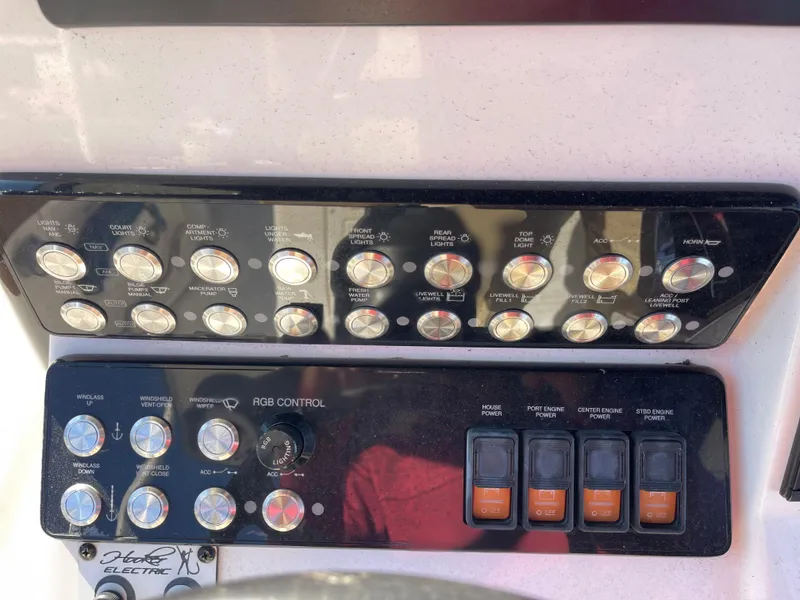 Slide: The Image of Control panel of 2022 Caymas 341 CC boat with various switches and buttons. - 34