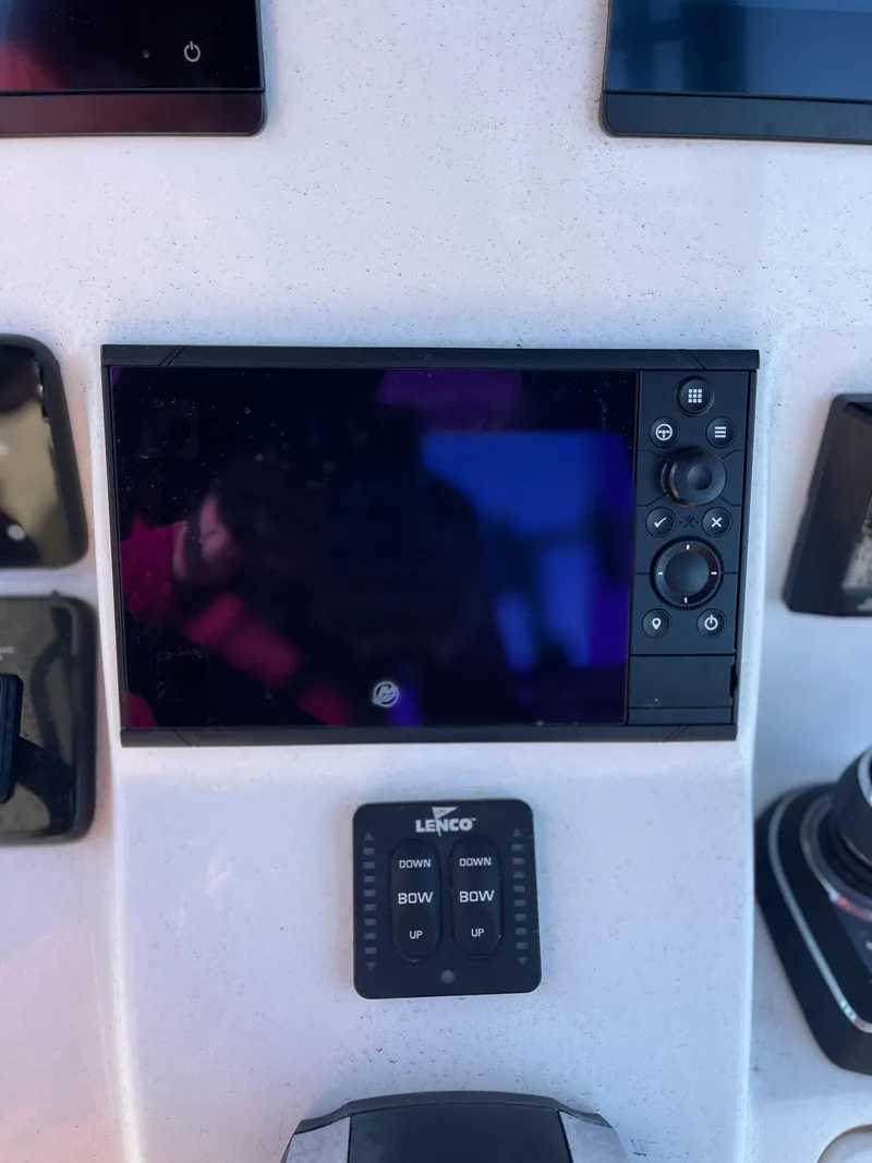 Slide: The Image of Control panel of 2022 Caymas 341 CC boat with electronic display and Lenco trim tab switch. - 35