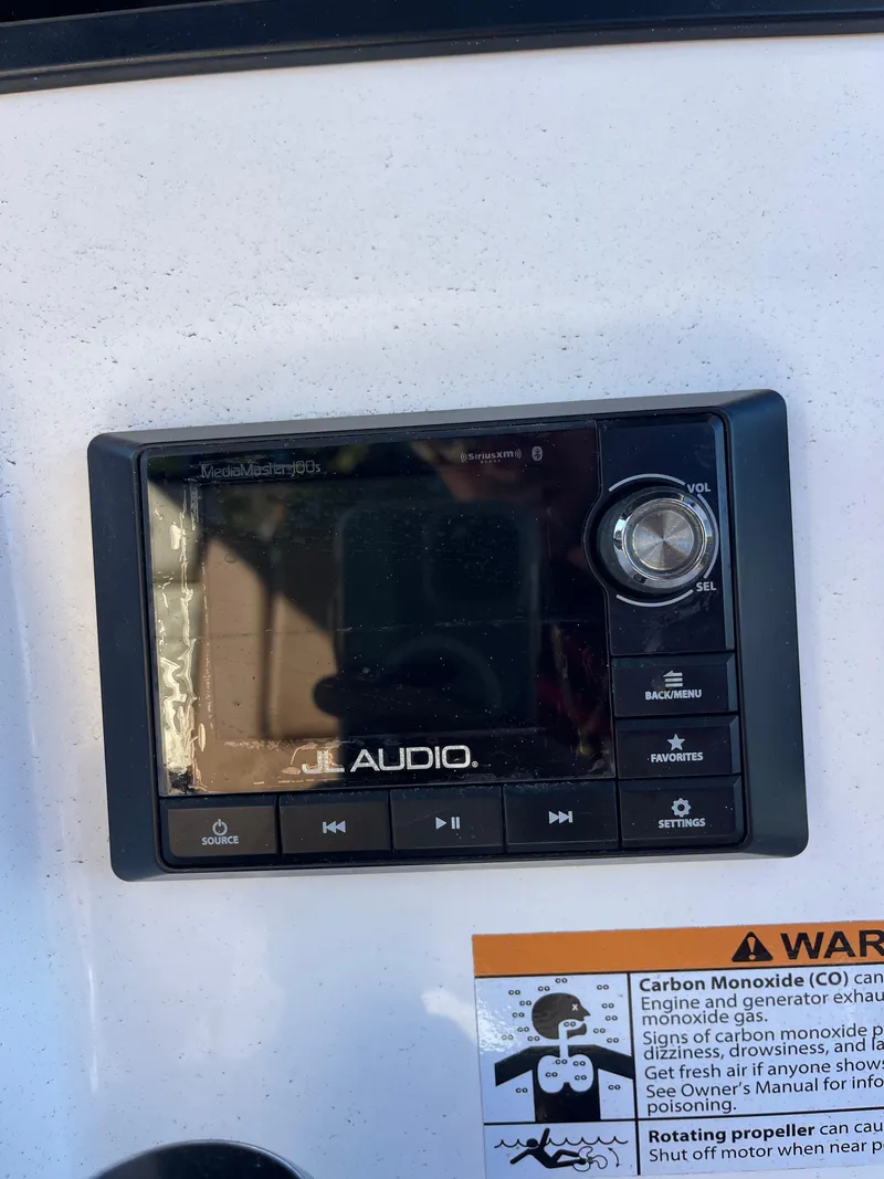 Slide: The Image of JL Audio system on 2022 Caymas 341 CC boat dashboard with warning label. - 36