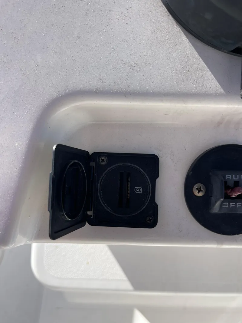 Slide: The Image of USB port and switch on 2022 Caymas 341 CC boat console. - 38