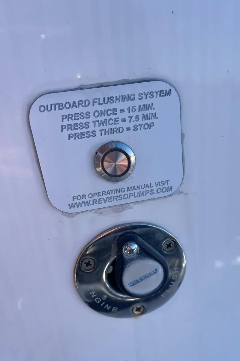 Slide: The Image of Outboard flushing system control on 2022 Caymas 341 CC boat, featuring a push-button mechanism. - 42