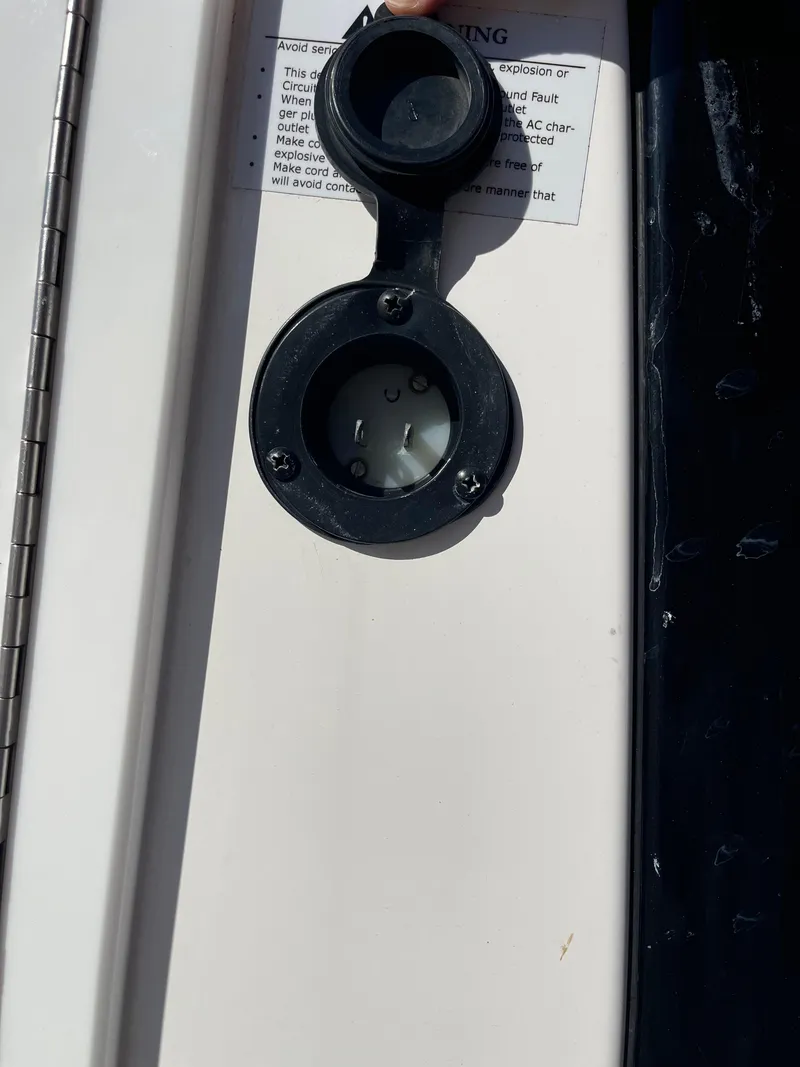 Slide: The Image of 2022 Caymas 341 CC boat detail showing a circular black fitting on a white surface. - 43