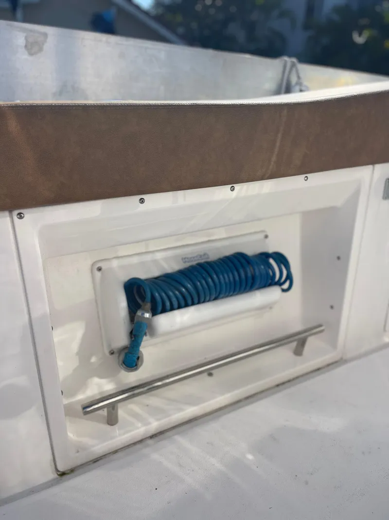 Slide: The Image of 2022 Caymas 341 CC boat detail with coiled blue hose and stainless steel rail. - 45