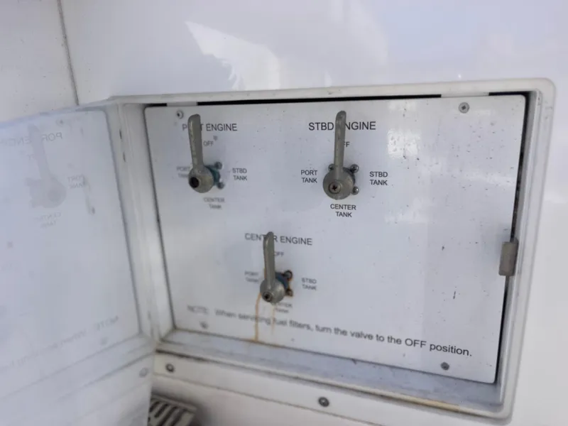 Slide: The Image of Control panel of a 2022 Caymas 341 CC boat showing engine fuel switches. - 47