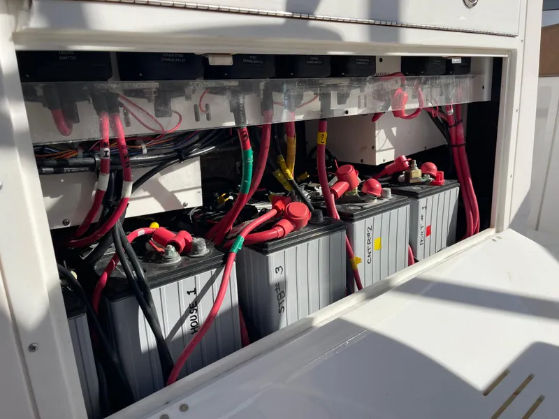 Slide: The Image of Battery compartment of 2022 Caymas 341 CC boat with multiple connected batteries. - 49