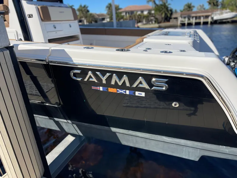 Slide: The Image of 2022 Caymas 341 CC boat docked, showcasing sleek design and branding. - 5