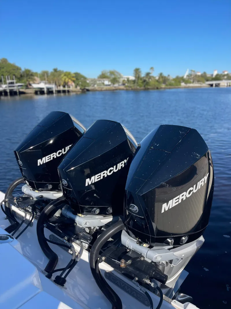 Slide: The Image of 2022 Caymas 341 CC boat with triple Mercury outboard engines on a calm waterway. - 6