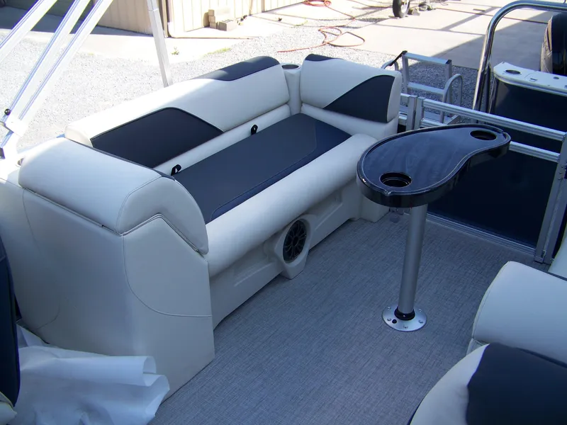 Slide: The Image of 2025 Avalon VENTURE QUAD LOUNGER interior with plush seating and sleek table design. - 10