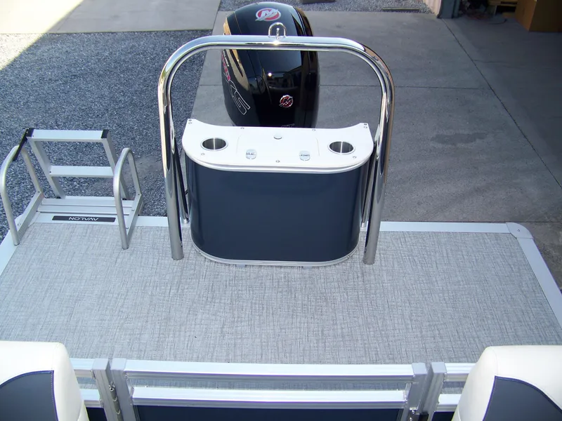 Slide: The Image of 2025 Avalon VENTURE QUAD LOUNGER boat deck with motor and ladder, featuring sleek design. - 11