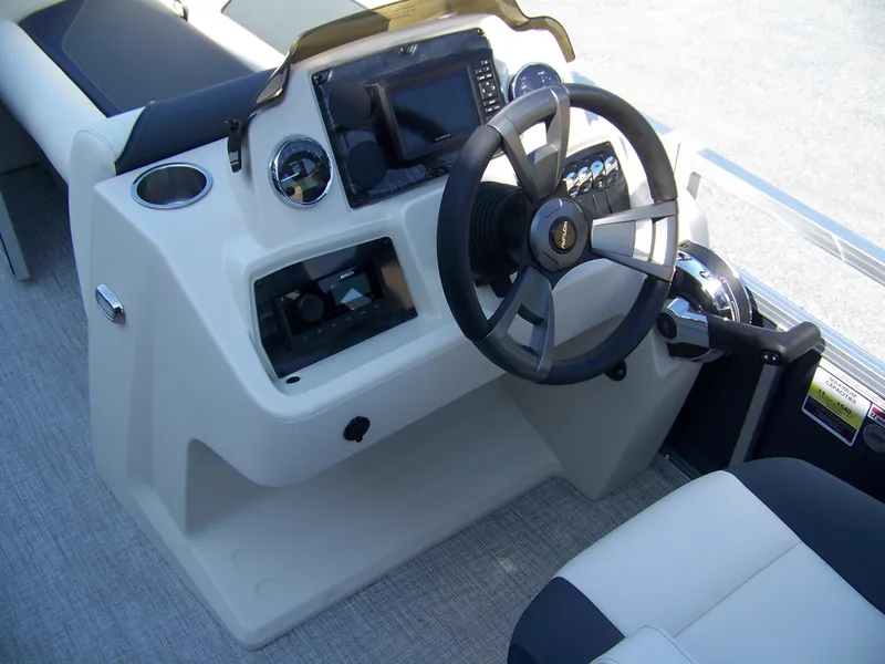 Slide: The Image of 2025 Avalon VENTURE QUAD LOUNGER boat dashboard with steering wheel and controls. - 7