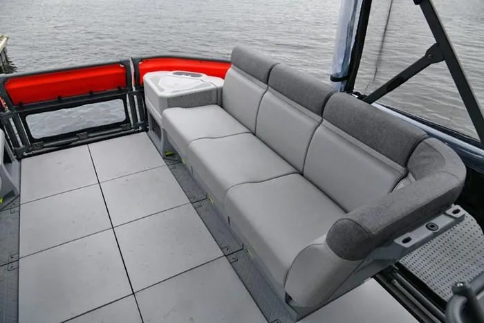 Slide: The Image of 2024 Sea-Doo Switch® Cruise 18 interior with gray seating, overlooking water. - 10