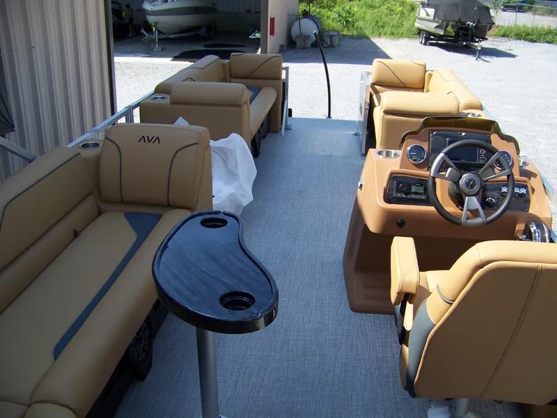 Slide: The Image of 2025 Avalon VENTURE CRUISE interior with tan seating and modern steering console. - 13