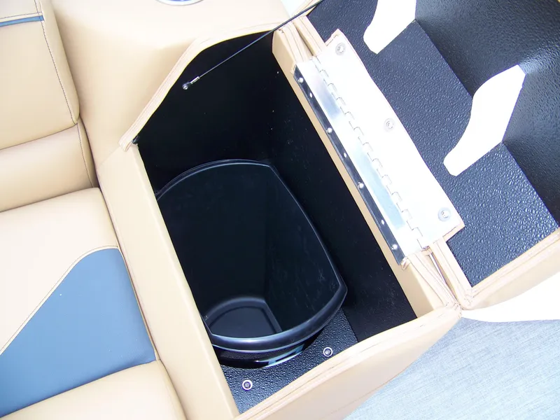 Slide: The Image of 2025 Avalon VENTURE CRUISE storage compartment with beige and black interior design. - 7