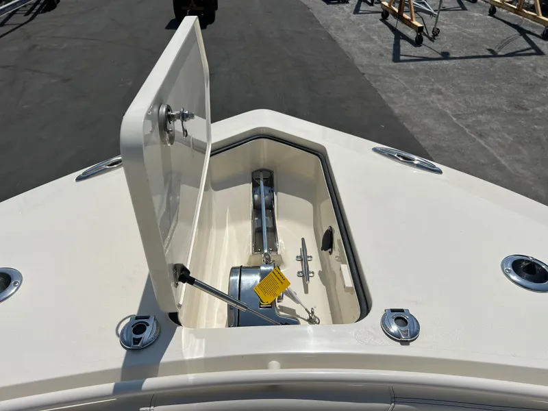 Slide: The Image of 2025 Scout 357 LXF boat anchor compartment open on deck. - 16