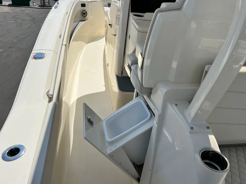 Slide: The Image of 2025 Scout 357 LXF boat interior with storage compartment and seating area. - 18